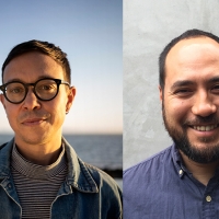 Two men, each looking straight ahead: both have short cropped dark hair, the one on the left in a turtleneck, jacket, wearing round glasses, on the right, the other wears a blue shirt and wide smile