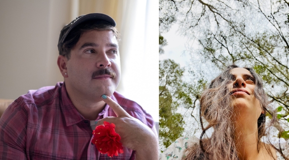 two poets: one in a small cap + dark moustache, holding a red flower; one looking up before a background of trees, long hair streaming